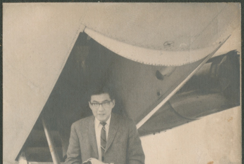Photo postcard of man getting off plane (ddr-densho-523-375)