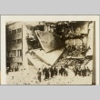 People looking at a building damaged in a bombing attack (ddr-njpa-13-1056)