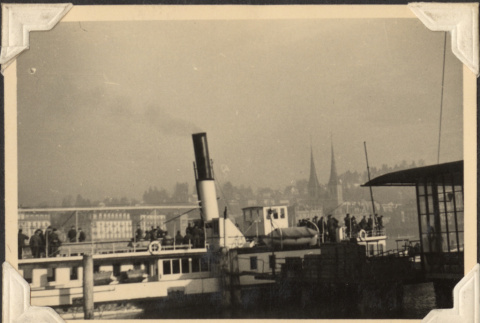 Boat at dock with city in background (ddr-densho-466-818)