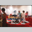 Two women by display of table settings (ddr-densho-426-374)