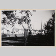 Man holding child in yard (ddr-densho-522-73)
