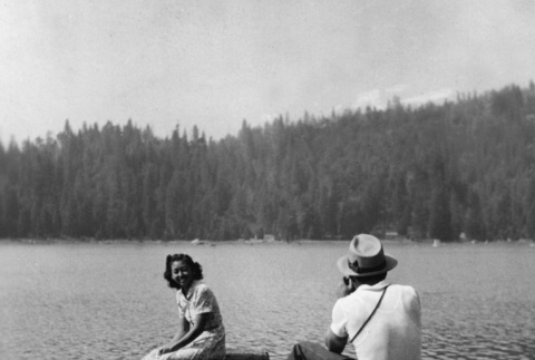 A man taking a photograph of Alice Abe on Lake Sequoia (ddr-densho-336-30)