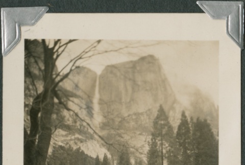 View of a lodge with Bridal Veil Falls in the distance (ddr-densho-321-476)