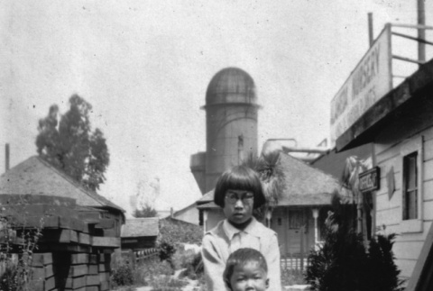 Girl and boy standing nursery yard (ddr-ajah-6-426)