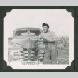 Man leaning against a car (ddr-densho-471-187)