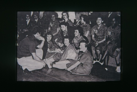 (Slide) - Image of girls in numbered uniforms seated. (ddr-densho-330-180-master-6ac8cafbd3)