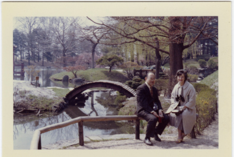 Kaneji Domoto with Elaine Reinelt sitting in Japanese Garden (ddr-densho-377-1350)