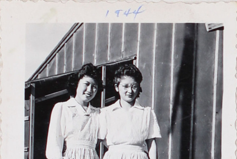 Two women standing outside barracks (ddr-densho-464-63)