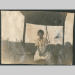 Woman sitting in shelter (ddr-densho-316-309)