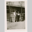 Two men standing outside barracks door (ddr-densho-329-1330)