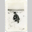 Herbert K. Yanamura kneeling in snow (ddr-densho-22-177)