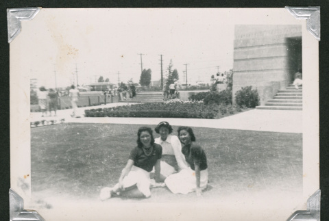 Three girls sitting on lawn (ddr-densho-550-134)