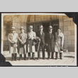 Group of 6 men standing in front of building (ddr-densho-326-340)