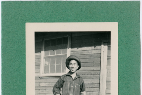 Man in fatigues standing outside barracks.  Inscription on front:  Joe- Fort Ord 1941 (ddr-ajah-2-7)