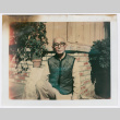Man poses outside house (ddr-densho-501-33)