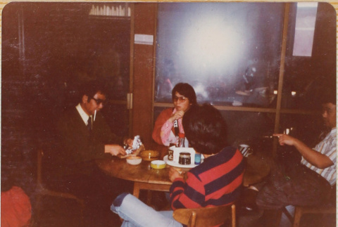 Four people at a table (ddr-densho-426-1253)