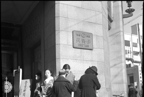 Women standing outside Isetan Department Store entrance (ddr-densho-426-306)
