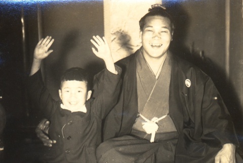 Sumo wrestler posing with a boy (ddr-njpa-4-2048)