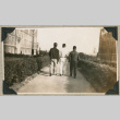 Three men walking on University of Washington campus (ddr-densho-383-165)
