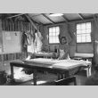 Woman cutting fabric (ddr-densho-115-2)