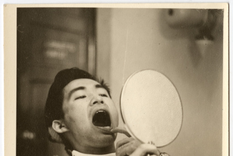 Man looking at his own teeth (ddr-densho-542-801)