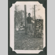 Man by log pile (ddr-densho-471-57)