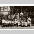Group of adults and children posing for photo outside building (ddr-ajah-4-2)