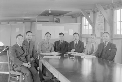 Men seated around a table in an office barracks (ddr-fom-1-380)
