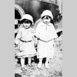 Sisters standing in front of a car (ddr-densho-18-43)