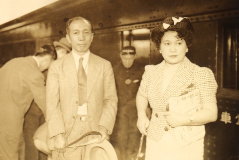 A man and woman at a train station (ddr-njpa-4-2842)