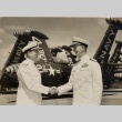 Felix B. Stump and Arthur W. Radford shaking hands on an aircraft carrier (ddr-njpa-2-930)