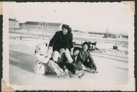 Ice skaters sitting on the ice (ddr-densho-463-95)