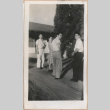 Group of people standing outside a home (ddr-manz-10-94)
