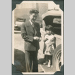 Man and girl standing on running board of car (ddr-densho-316-362)