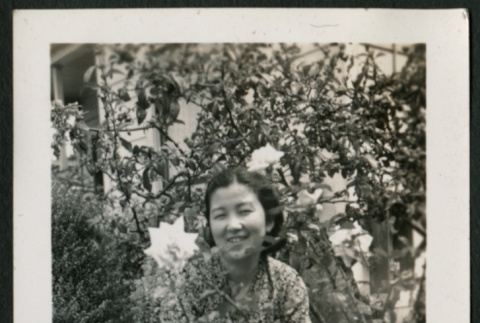 Woman poses in garden (ddr-densho-359-1009)