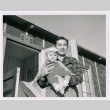 Paul Nakadate with baby in front of barracks (ddr-densho-122-654)