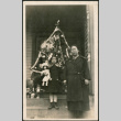 Woman and girl with dolls standing in from of Christmas tree (ddr-densho-293-66)
