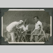 3 men sitting near harbor (ddr-densho-540-65)