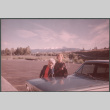 Two women next to car in parking lot (ddr-densho-523-607)