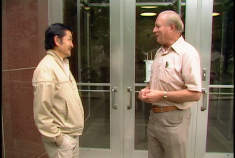 William Kochiyama and Robert H. Foote meeting and walking through barn (ddr-densho-1007-1517)