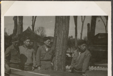 Four men at table tennis table (ddr-densho-466-21)