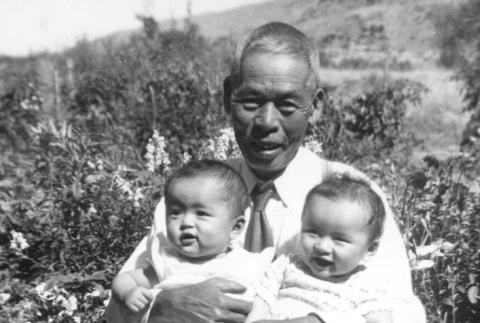 Issei man holding two children (ddr-densho-2-54)