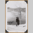 Man and woman walking in the snow (ddr-densho-542-319)
