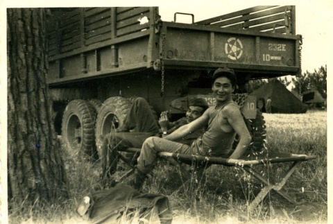 Soldiers relaxing on a cot (ddr-densho-22-235)