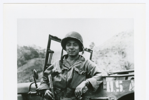 U.S. soldier leaning against car (ddr-densho-1007-354)