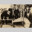 Men in uniform and street clothes in a shipyard (ddr-njpa-1-2594)