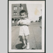 Photo of a child holding a bag (ddr-densho-483-721)