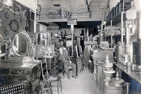 Chosaku Hashiguchi and unidentified man sitting inside American Furniture Company (ddr-densho-474-204)