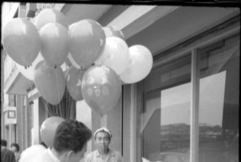 Balloon seller with two small girls (ddr-densho-426-2306)