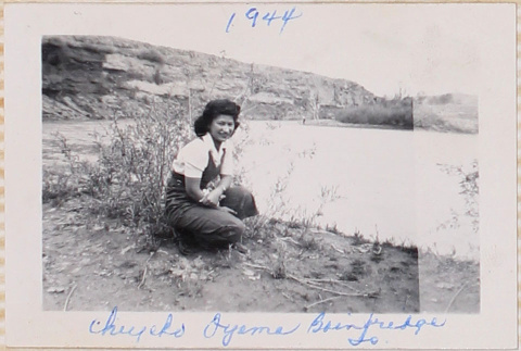 Woman kneeling next to pond (ddr-densho-464-24)